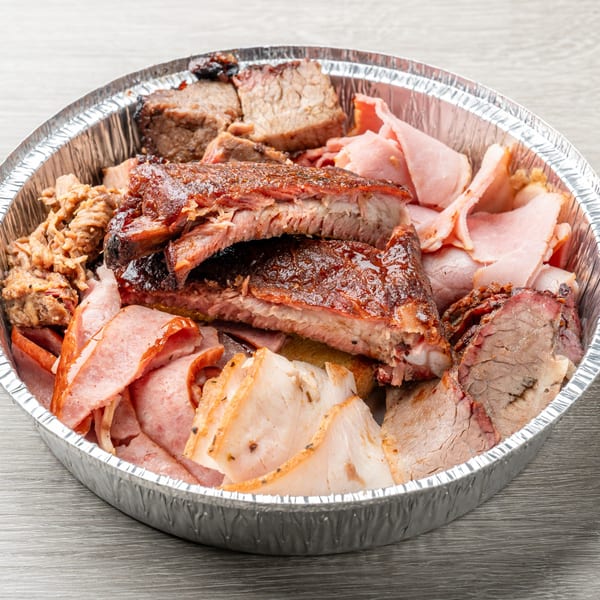 Hawg Jaw Que & Brew's large platter of assorted BBQ meats, including ribs, brisket, and pulled pork.